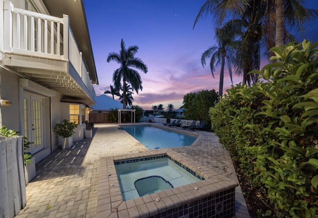 121 Queen Eugenia Ct, Hutchinson Island, FL 34949 - view of swimming pool with fence, a patio, french doors, an in ground hot tub, and a fenced in pool