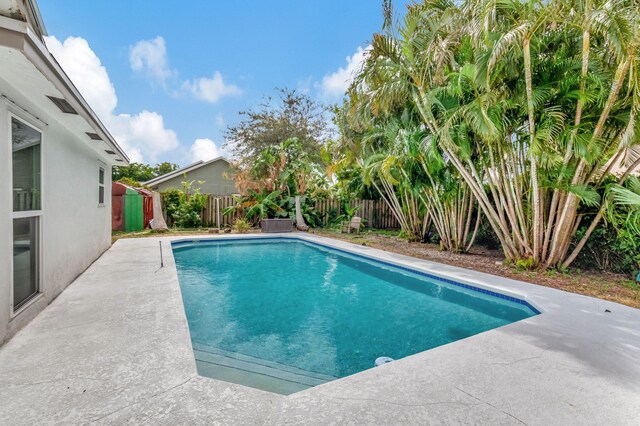 3030 Phoebe Ln, Delray Beach, FL 33444 - view of swimming pool featuring a fenced in pool, a patio, and a fenced backyard