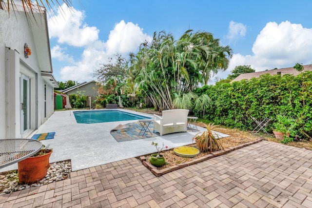 3030 Phoebe Ln, Delray Beach, FL 33444 - view of swimming pool with a patio, a fenced in pool, and a fenced backyard
