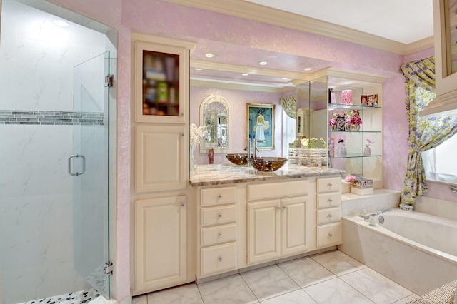 full bathroom featuring vanity, a bath, ornamental molding, and a stall shower