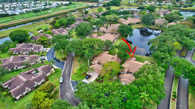 birds eye view of property featuring a water view and a residential view