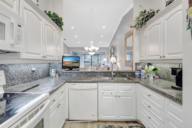 kitchen with a sink, decorative backsplash, white appliances, and crown molding