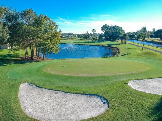 view of property's community with view of golf course and a water view