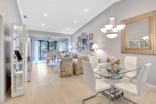 dining space featuring visible vents, baseboards, a notable chandelier, ornamental molding, and light wood-style floors