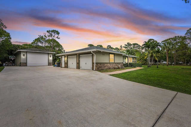 12109 53rd Rd N, The Acreage, FL 33411 - view of front of home with stone siding, stucco siding, a yard, and a garage