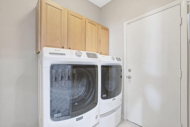 laundry area featuring washer and dryer and cabinet space