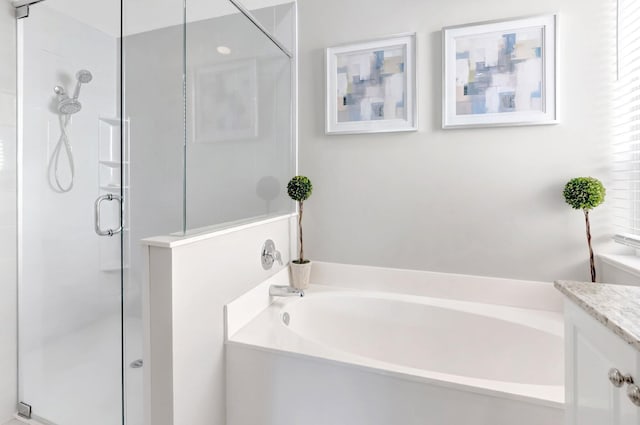 full bath featuring vanity, a bath, and a stall shower