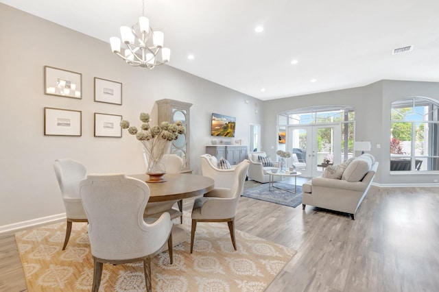 dining space with visible vents, baseboards, a notable chandelier, recessed lighting, and light wood-style flooring