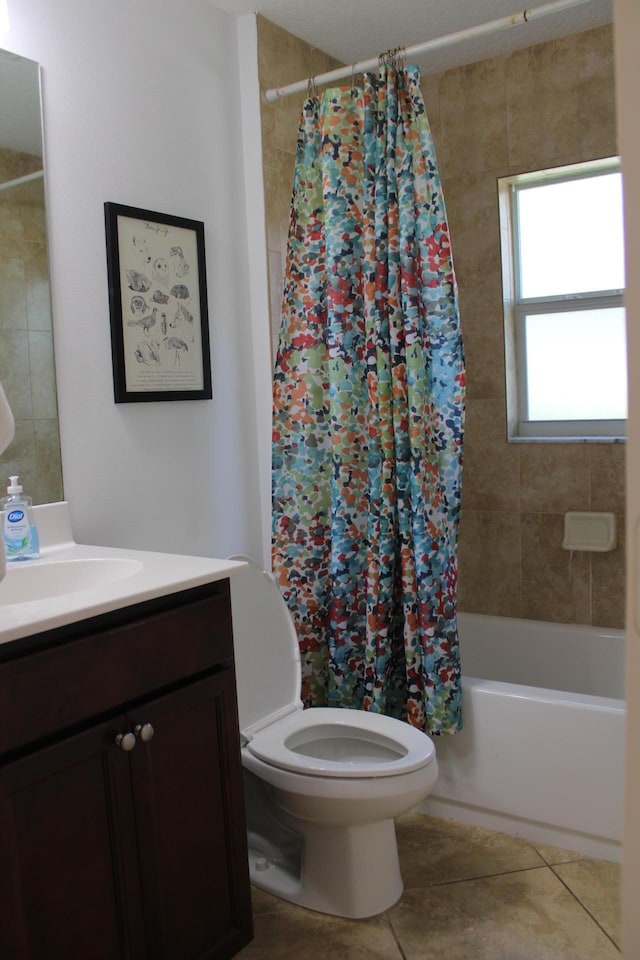 bathroom featuring tile patterned flooring, shower / bathtub combination with curtain, vanity, and toilet