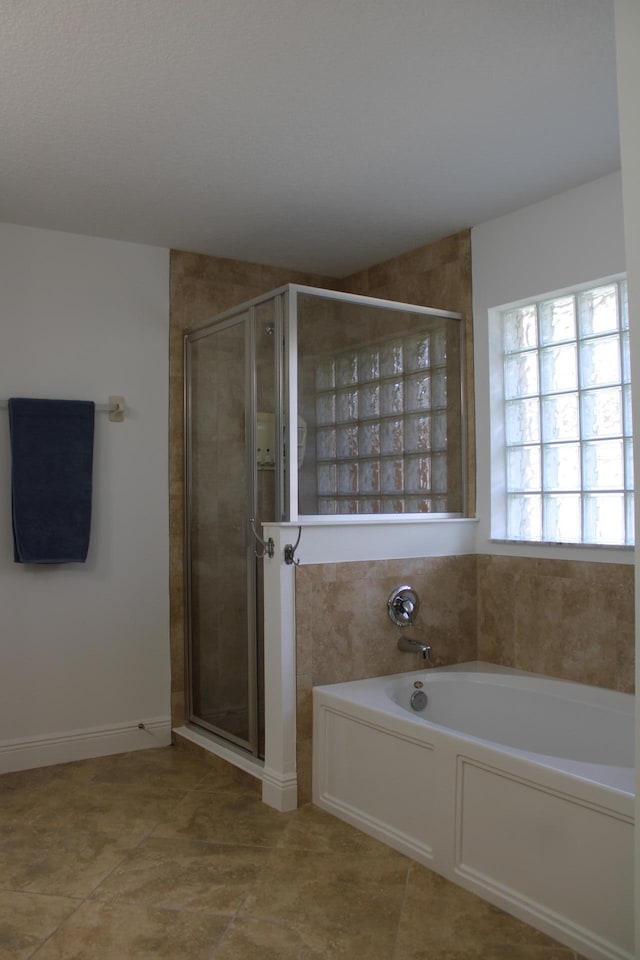 full bath featuring a bath, a stall shower, and tile patterned flooring