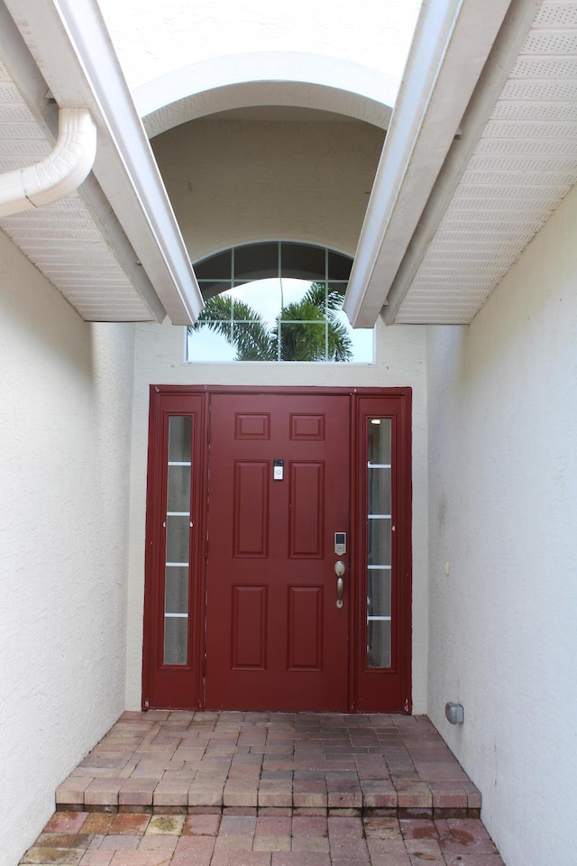 entrance to property with stucco siding