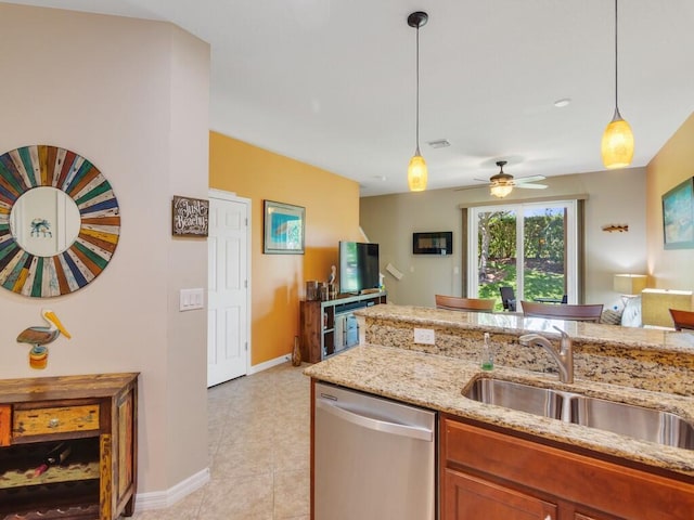 kitchen with stainless steel dishwasher, a sink, brown cabinetry, light stone countertops, and open floor plan