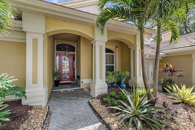 view of exterior entry featuring stucco siding