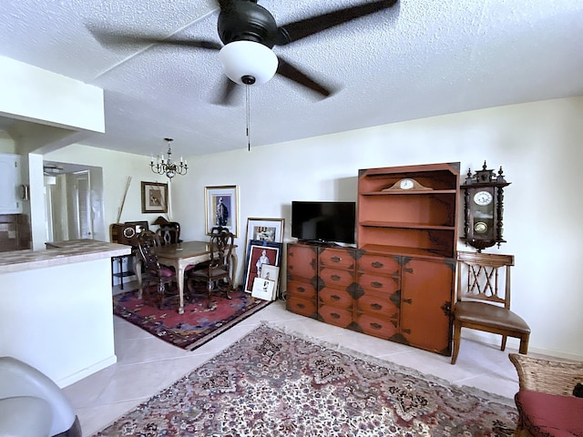 191 Durham D, Deerfield Beach, FL 33442 - living area featuring light tile patterned floors, ceiling fan with notable chandelier, and a textured ceiling