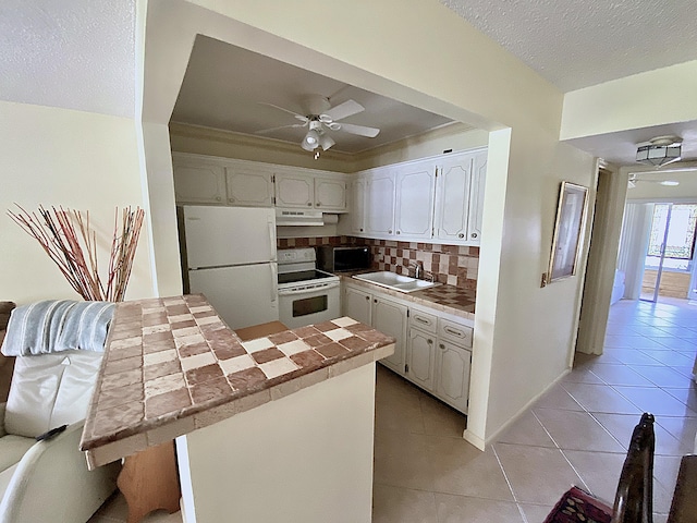 191 Durham D, Deerfield Beach, FL 33442 - kitchen featuring tasteful backsplash, a ceiling fan, white appliances, under cabinet range hood, and white cabinetry