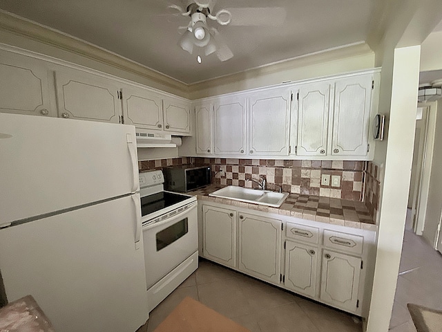 191 Durham D, Deerfield Beach, FL 33442 - kitchen with white appliances, under cabinet range hood, light tile patterned flooring, a sink, and decorative backsplash