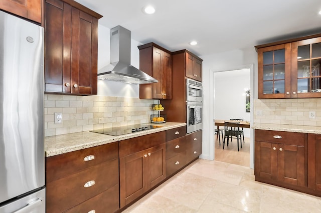 6769 Entrada Pl, Boca Raton, FL 33433 - kitchen with stainless steel appliances, wall chimney range hood, glass insert cabinets, backsplash, and recessed lighting