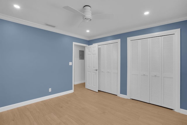 6769 Entrada Pl, Boca Raton, FL 33433 - unfurnished bedroom with multiple closets, ornamental molding, wood finished floors, electric panel, and recessed lighting