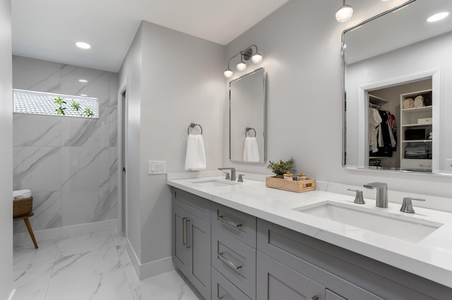 6769 Entrada Pl, Boca Raton, FL 33433 - bathroom featuring marble finish flooring, double vanity, baseboards, a marble finish shower, and a walk in closet