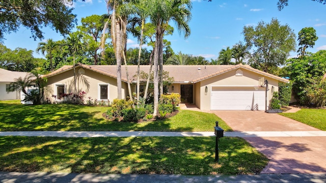 6769 Entrada Pl, Boca Raton, FL 33433 - ranch-style house with a tile roof, stucco siding, an attached garage, and a front yard