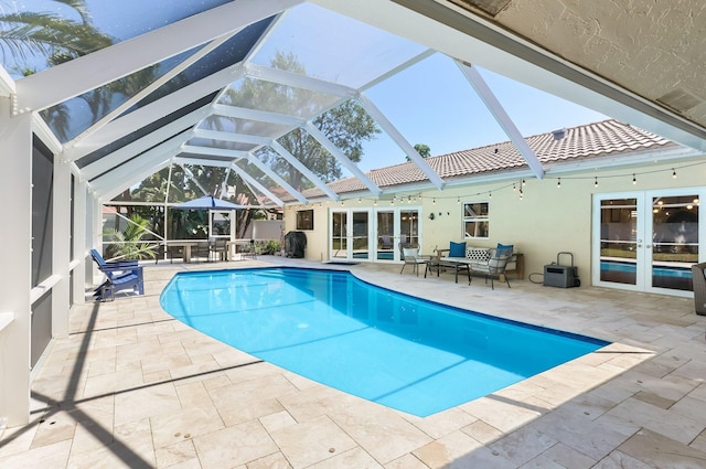 6769 Entrada Pl, Boca Raton, FL 33433 - outdoor pool with french doors, a patio, outdoor lounge area, and glass enclosure