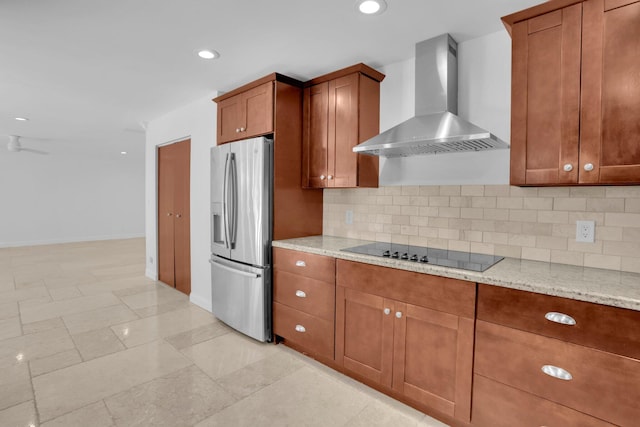 6769 Entrada Pl, Boca Raton, FL 33433 - kitchen featuring stainless steel refrigerator with ice dispenser, wall chimney exhaust hood, black electric stovetop, brown cabinetry, and light stone countertops