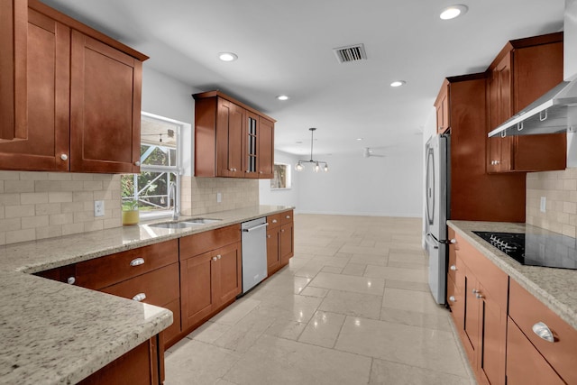 6769 Entrada Pl, Boca Raton, FL 33433 - kitchen with appliances with stainless steel finishes, wall chimney range hood, recessed lighting, light stone counters, and decorative backsplash