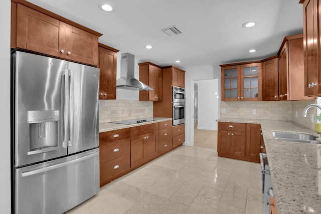 6769 Entrada Pl, Boca Raton, FL 33433 - kitchen with stainless steel appliances, wall chimney exhaust hood, glass insert cabinets, light stone countertops, and brown cabinets