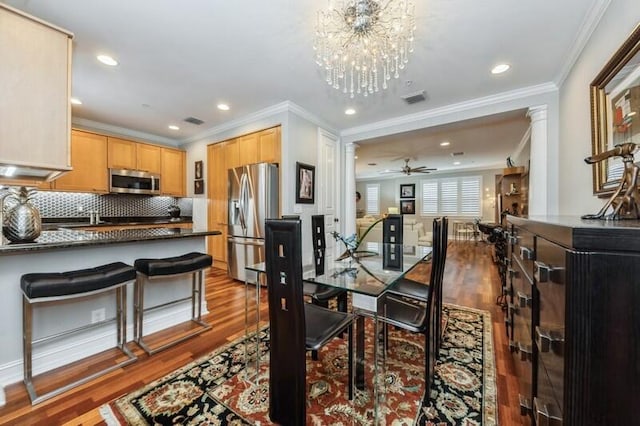 310 E Mallory Cir, Delray Beach, FL 33483 - dining area featuring visible vents, ornamental molding, and wood finished floors