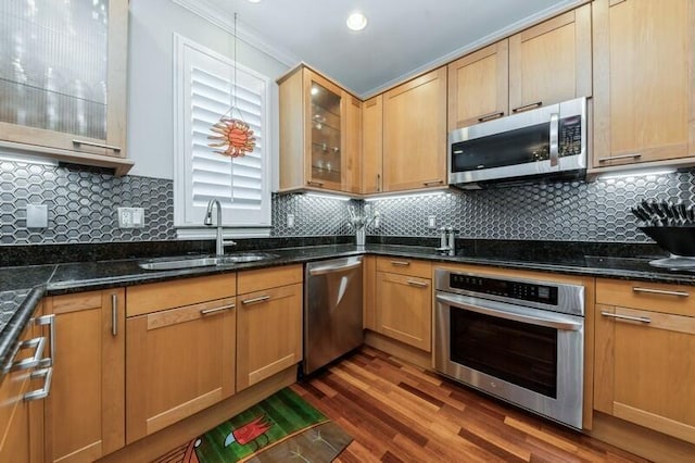 310 E Mallory Cir, Delray Beach, FL 33483 - kitchen featuring glass insert cabinets, dark wood-type flooring, dark stone counters, stainless steel appliances, and a sink