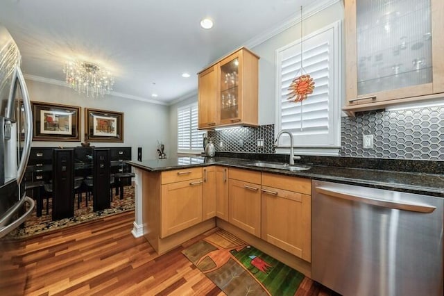 310 E Mallory Cir, Delray Beach, FL 33483 - kitchen featuring dark wood-style flooring, a peninsula, crown molding, stainless steel appliances, and a sink