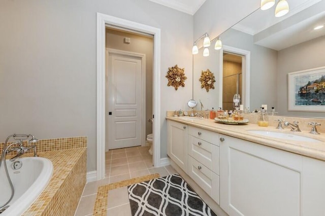 310 E Mallory Cir, Delray Beach, FL 33483 - bathroom featuring a bath, toilet, a sink, tile patterned floors, and double vanity