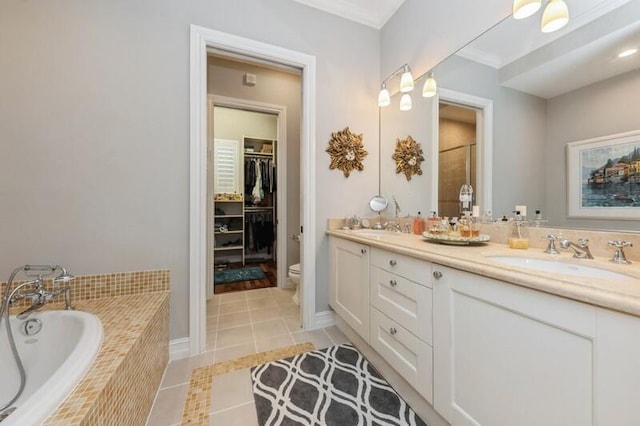 310 E Mallory Cir, Delray Beach, FL 33483 - bathroom with a garden tub, tile patterned flooring, a sink, a walk in closet, and double vanity