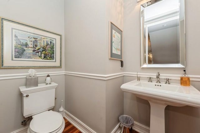 310 E Mallory Cir, Delray Beach, FL 33483 - half bath featuring toilet, wood finished floors, a sink, and baseboards
