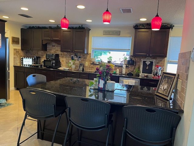 1380 SW 1st St, Boca Raton, FL 33486 - kitchen featuring crown molding, tasteful backsplash, pendant lighting, light tile patterned floors, and dark brown cabinets