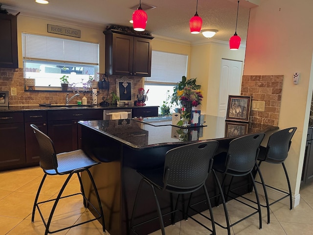 1380 SW 1st St, Boca Raton, FL 33486 - kitchen featuring light tile patterned flooring, ornamental molding, a breakfast bar, backsplash, and dishwasher
