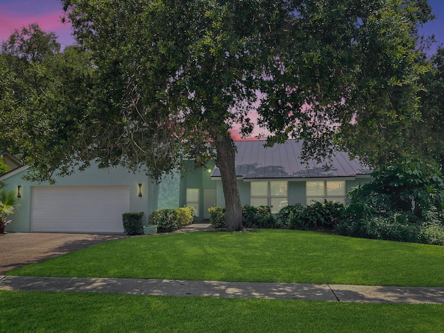 1380 SW 1st St, Boca Raton, FL 33486 - view of front of house with driveway, a yard, stucco siding, a garage, and a metal roof