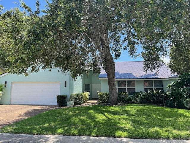 1380 SW 1st St, Boca Raton, FL 33486 - view of front of property featuring stucco siding, a front lawn, concrete driveway, and a standing seam roof
