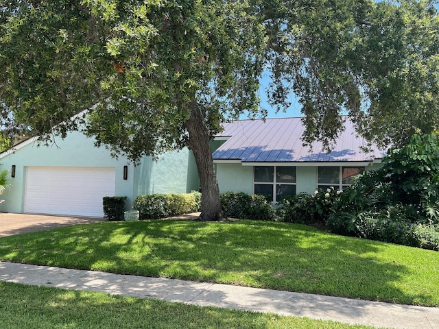 1380 SW 1st St, Boca Raton, FL 33486 - view of front facade featuring stucco siding, a front lawn, an attached garage, driveway, and a metal roof