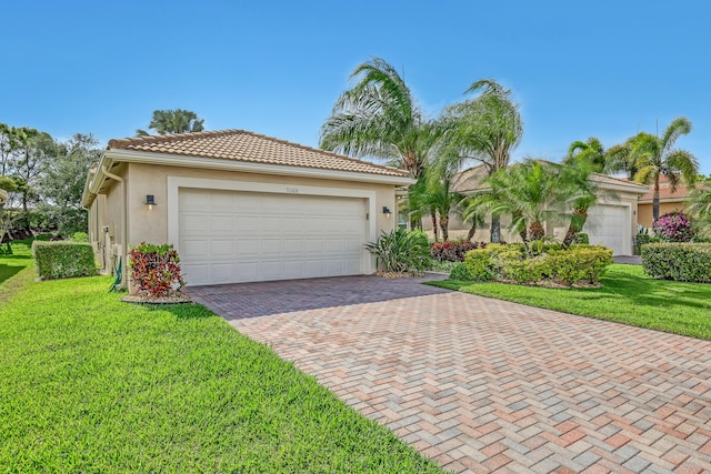 9068 Clearhill Rd, Boynton Beach, FL 33473 - mediterranean / spanish home featuring stucco siding, decorative driveway, an attached garage, a front yard, and a tiled roof