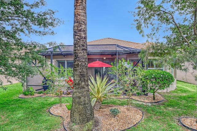 9068 Clearhill Rd, Boynton Beach, FL 33473 - exterior space featuring a yard, stucco siding, a tile roof, and glass enclosure