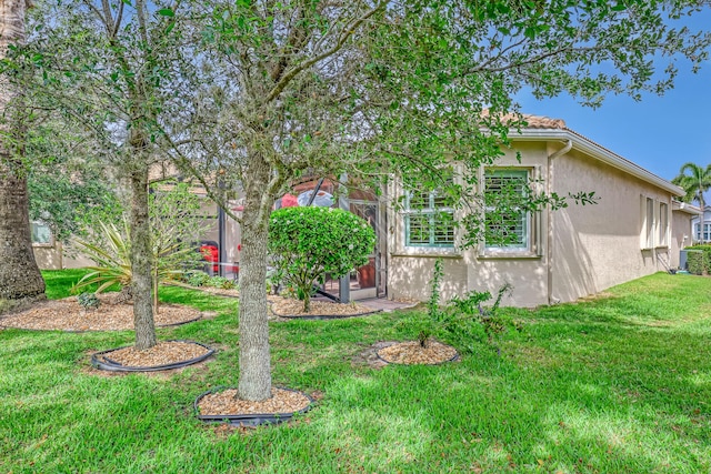 9068 Clearhill Rd, Boynton Beach, FL 33473 - view of side of home with stucco siding and a lawn