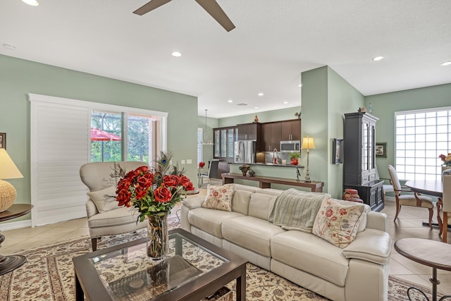 9068 Clearhill Rd, Boynton Beach, FL 33473 - living room featuring light tile patterned floors, a ceiling fan, recessed lighting, and a healthy amount of sunlight