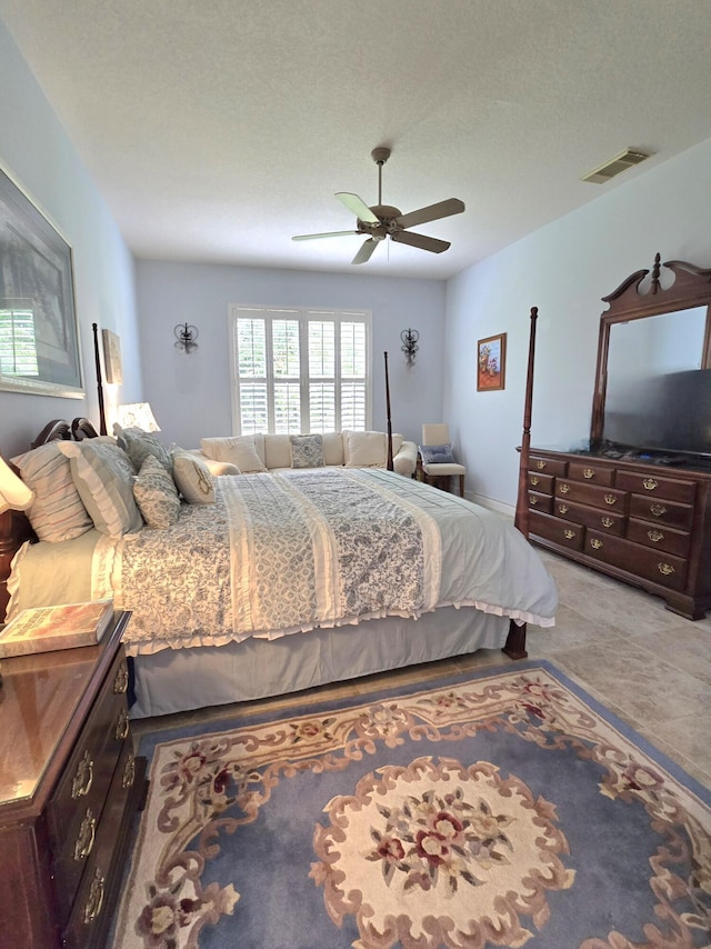 630 SW Treasure Cv, Port Saint Lucie, FL 34953 - bedroom with ceiling fan, a textured ceiling, and visible vents