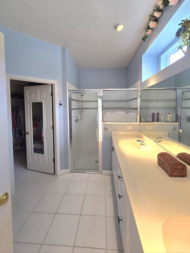 630 SW Treasure Cv, Port Saint Lucie, FL 34953 - full bath featuring double vanity, a sink, a stall shower, and tile patterned floors