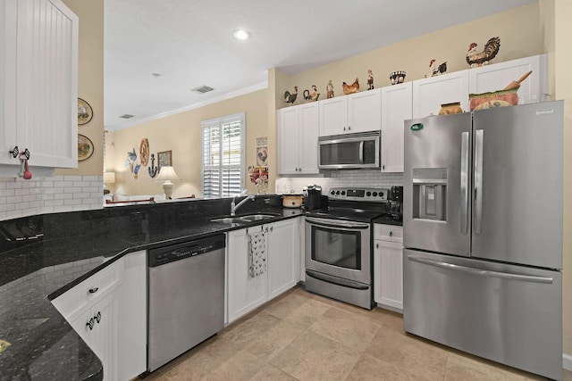 630 SW Treasure Cv, Port Saint Lucie, FL 34953 - kitchen featuring stainless steel appliances, ornamental molding, decorative backsplash, and a sink