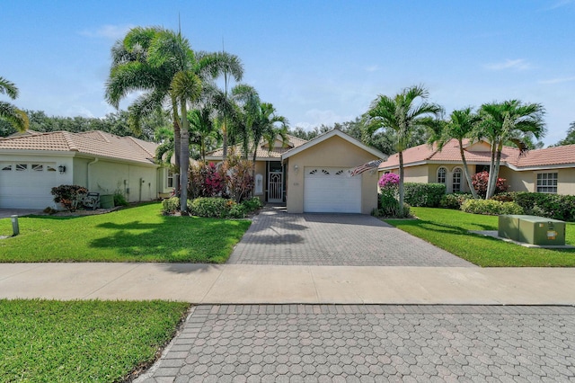 630 SW Treasure Cv, Port Saint Lucie, FL 34953 - single story home with decorative driveway, a garage, stucco siding, and a front yard