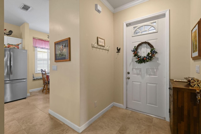 630 SW Treasure Cv, Port Saint Lucie, FL 34953 - foyer entrance with visible vents, ornamental molding, baseboards, and light tile patterned flooring