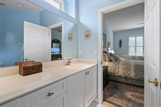 630 SW Treasure Cv, Port Saint Lucie, FL 34953 - ensuite bathroom featuring connected bathroom, visible vents, and vanity