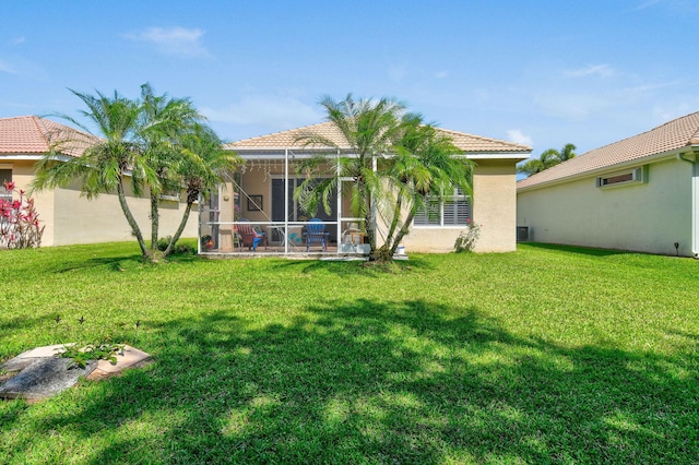 630 SW Treasure Cv, Port Saint Lucie, FL 34953 - back of property featuring a wall mounted air conditioner, a lanai, stucco siding, and a yard